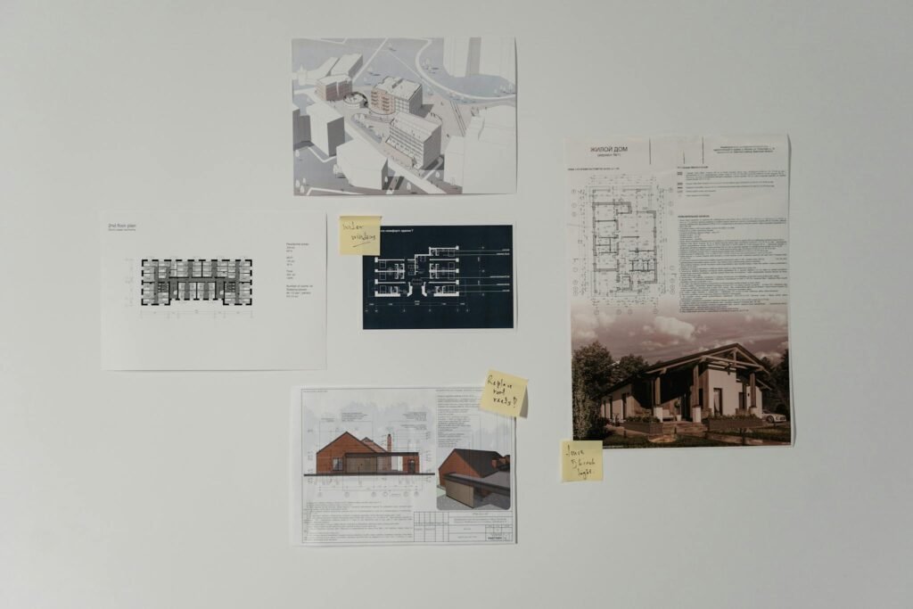 Collection of architectural blueprints and design sketches on a wall, showcasing modern building planning.